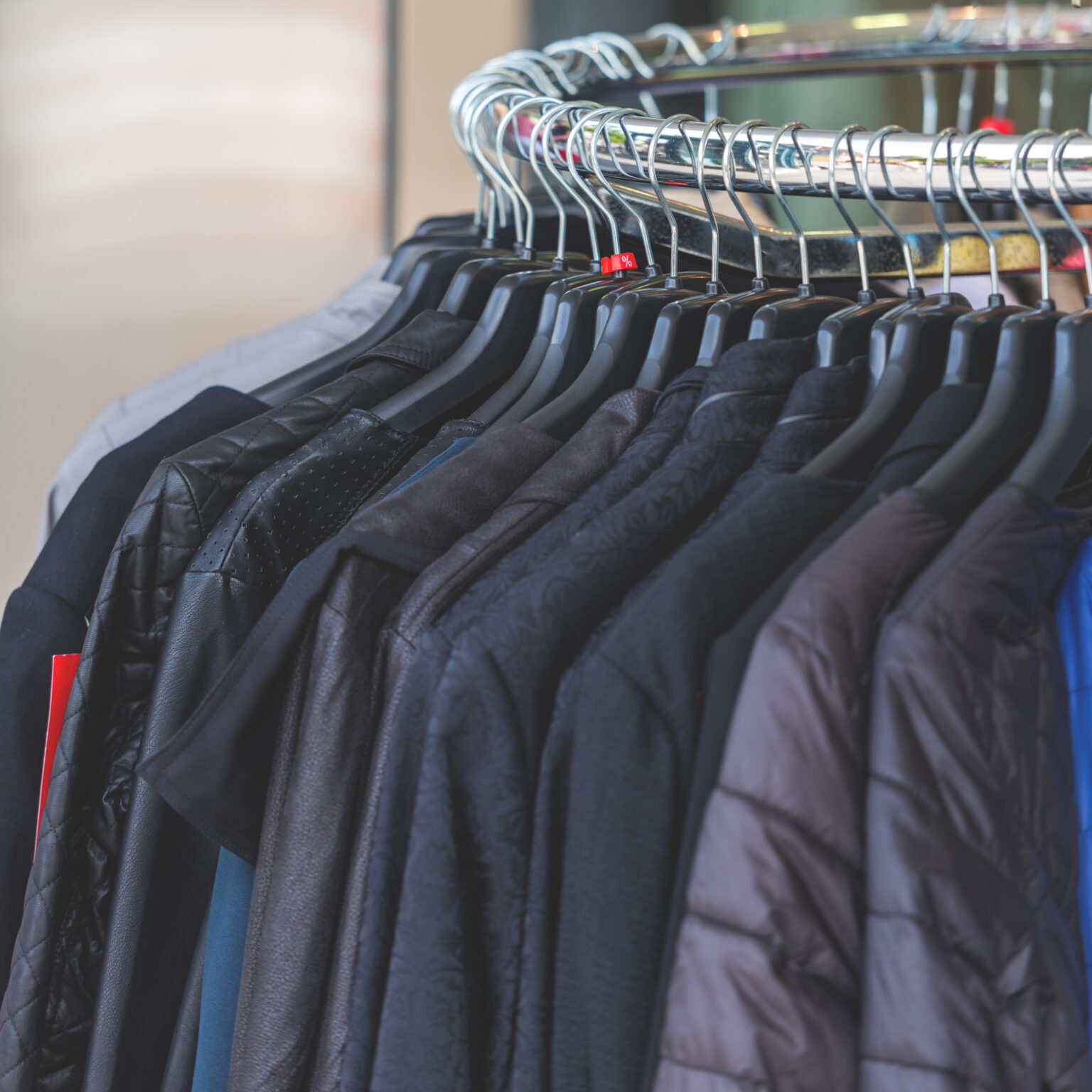 Dark autumn clothes hanging at a store. CloseUp shot with a selective focus